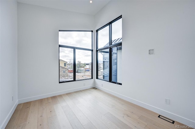 spare room featuring light wood-type flooring