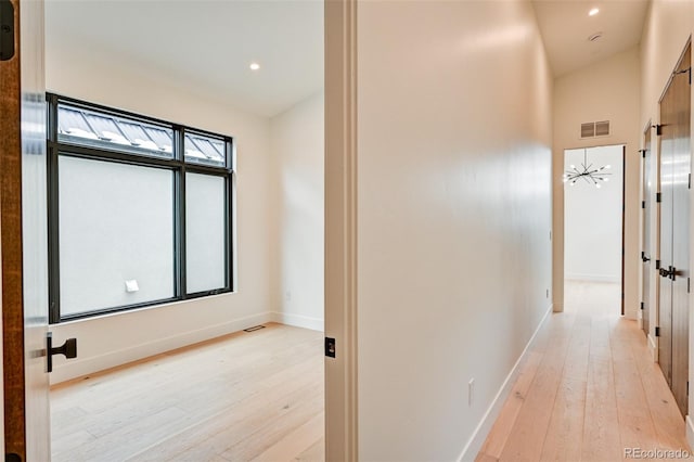 corridor with light hardwood / wood-style flooring