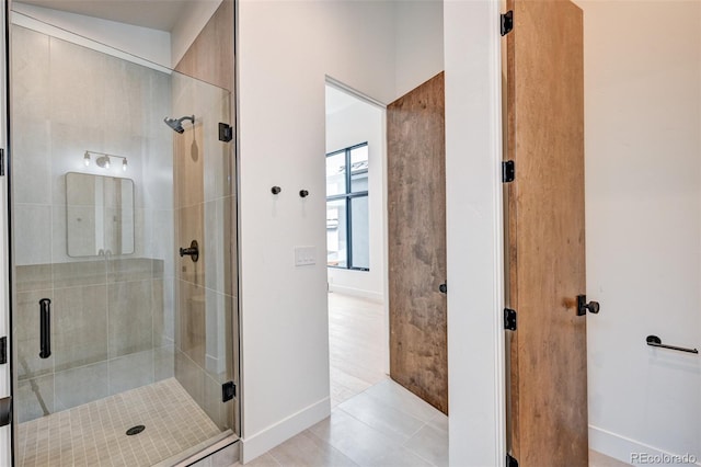 bathroom with walk in shower and tile patterned flooring