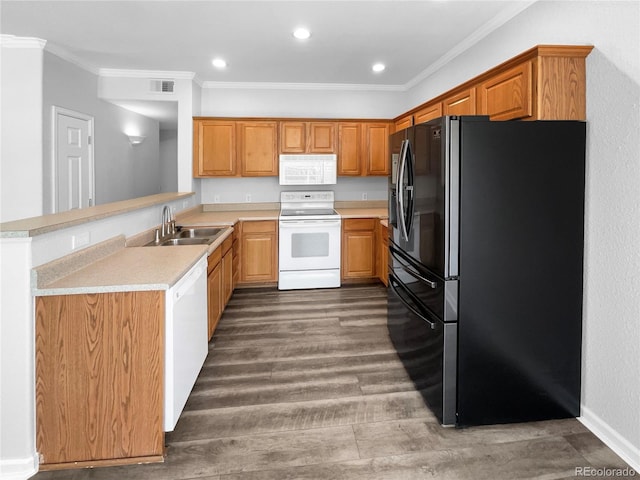 kitchen with white appliances, sink, kitchen peninsula, wood-type flooring, and ornamental molding