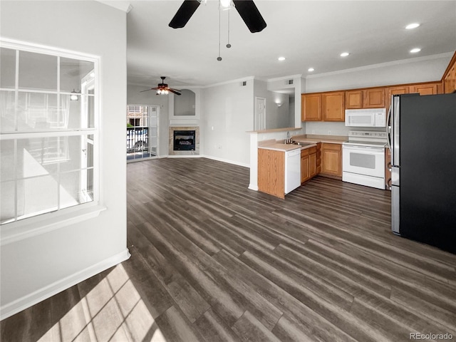 kitchen featuring ceiling fan, white appliances, ornamental molding, kitchen peninsula, and dark wood-type flooring