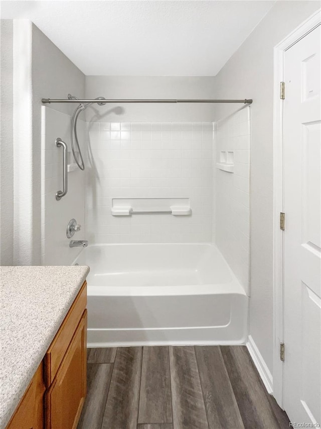 bathroom featuring vanity, bathtub / shower combination, and hardwood / wood-style floors