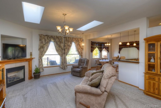 698 Larimer Creek Dr, Monument, CO 80132 - carpeted living room with a skylight, a chandelier, baseboards, and a tiled fireplace