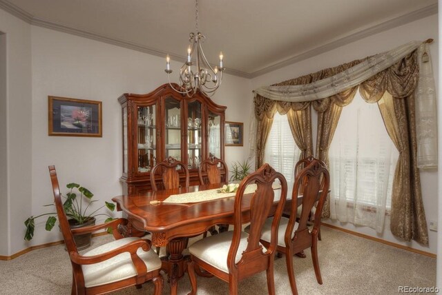 698 Larimer Creek Dr, Monument, CO 80132 - dining room with a chandelier, carpet, crown molding, and baseboards
