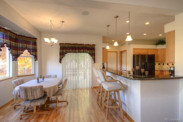 698 Larimer Creek Dr, Monument, CO 80132 - dining space with light wood-type flooring, a chandelier, baseboards, and recessed lighting