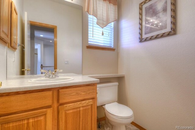 698 Larimer Creek Dr, Monument, CO 80132 - half bathroom with toilet, vanity, and baseboards