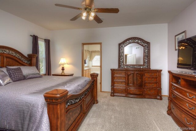 698 Larimer Creek Dr, Monument, CO 80132 - bedroom with multiple windows, light colored carpet, connected bathroom, and a ceiling fan