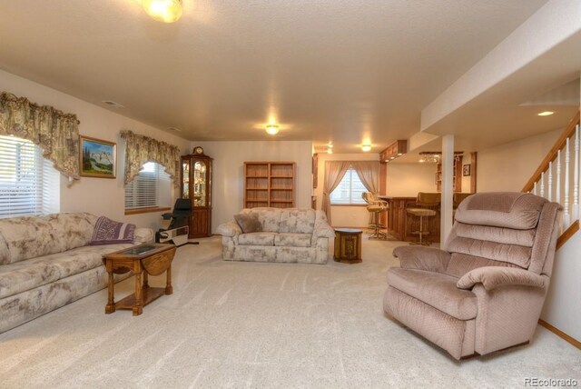 698 Larimer Creek Dr, Monument, CO 80132 - living area with a dry bar, carpet floors, and stairway