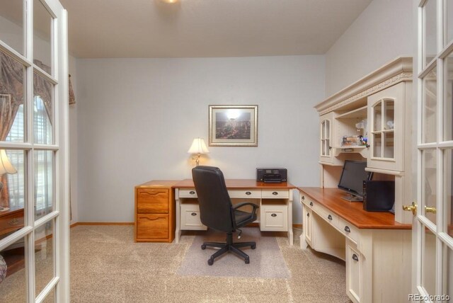 698 Larimer Creek Dr, Monument, CO 80132 - home office with light colored carpet, french doors, and baseboards