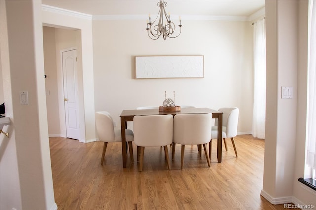 698 Larimer Creek Dr, Monument, CO 80132 - dining area with a chandelier, light wood-style flooring, and crown molding