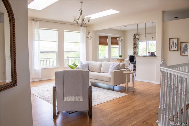 698 Larimer Creek Dr, Monument, CO 80132 - living area featuring a chandelier, wood finished floors, and a skylight