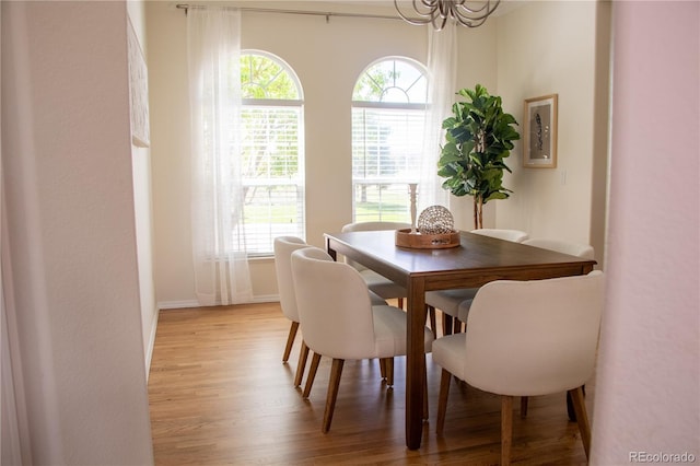 698 Larimer Creek Dr, Monument, CO 80132 - dining room featuring light wood finished floors and a chandelier