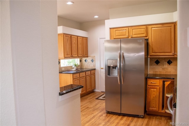 698 Larimer Creek Dr, Monument, CO 80132 - kitchen with stainless steel fridge with ice dispenser, backsplash, light wood finished floors, and recessed lighting