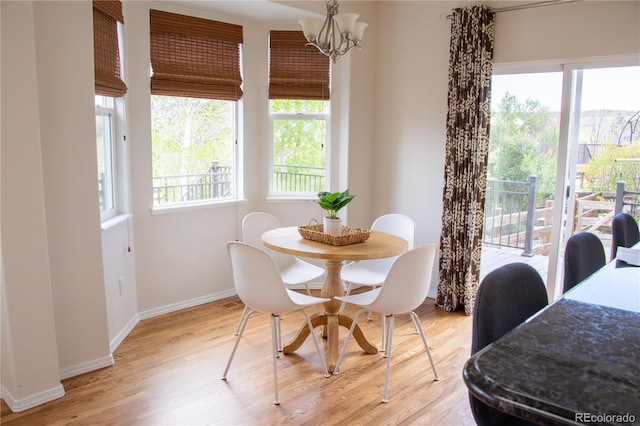 698 Larimer Creek Dr, Monument, CO 80132 - dining area with light wood finished floors and a chandelier