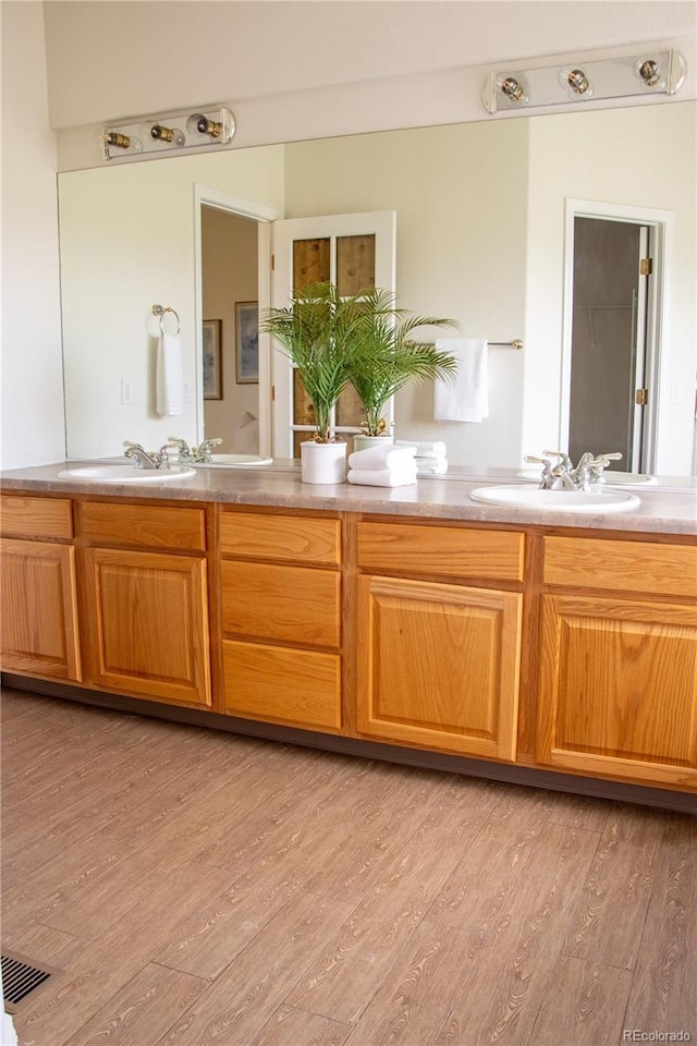 698 Larimer Creek Dr, Monument, CO 80132 - bathroom with double vanity and wood finished floors