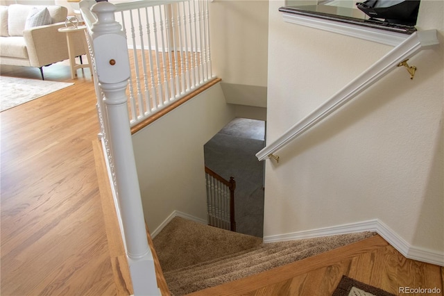 698 Larimer Creek Dr, Monument, CO 80132 - staircase featuring baseboards and wood finished floors