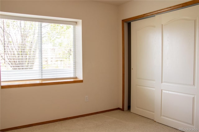 698 Larimer Creek Dr, Monument, CO 80132 - unfurnished bedroom featuring a closet, light colored carpet, and multiple windows