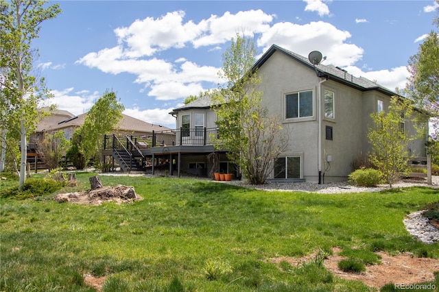 698 Larimer Creek Dr, Monument, CO 80132 - rear view of property with stairs, a wooden deck, stucco siding, and a yard