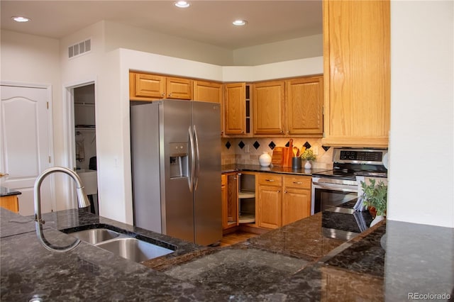 698 Larimer Creek Dr, Monument, CO 80132 - kitchen with appliances with stainless steel finishes, dark stone counters, backsplash, and recessed lighting