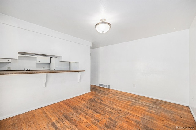 1533 S Jamaica St, Aurora, CO 80012 - unfurnished living room featuring hardwood / wood-style floors and baseboards