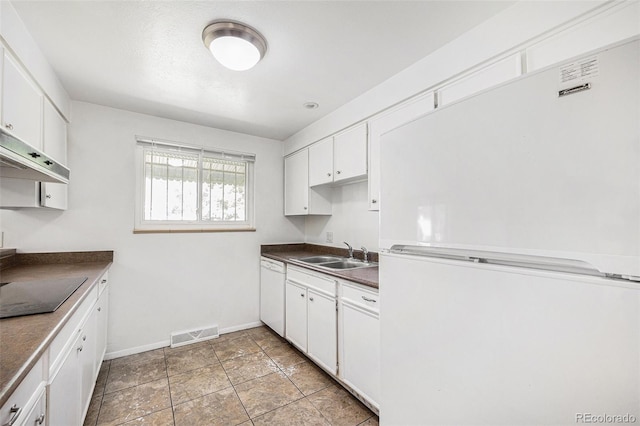 1533 S Jamaica St, Aurora, CO 80012 - kitchen with white appliances, dark countertops, white cabinetry, and under cabinet range hood