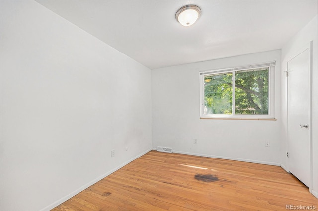 1533 S Jamaica St, Aurora, CO 80012 - spare room featuring light wood-style flooring and baseboards