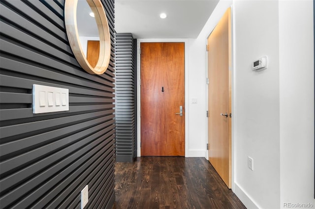 hallway with dark hardwood / wood-style flooring