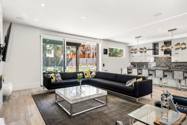 living area with light wood finished floors and recessed lighting