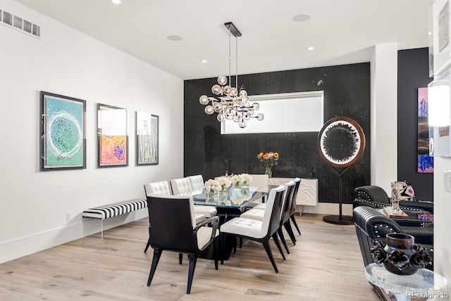 dining room with wood finished floors, an inviting chandelier, visible vents, and recessed lighting