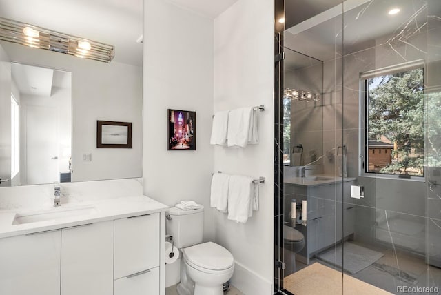 full bath with vanity, a stall shower, and toilet