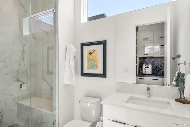 bathroom with toilet, vanity, and a marble finish shower