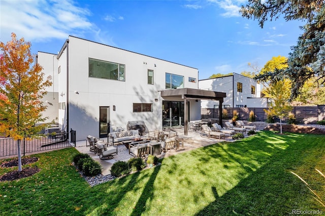 rear view of property with a yard, an outdoor living space, fence, a patio, and stucco siding