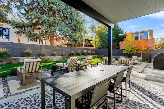 view of patio with a fenced backyard, outdoor dining area, and an outdoor hangout area