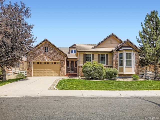 14310 Kalamath St, Westminster, CO 80023 - view of front of home featuring a garage, a tiled roof, driveway, and brick siding