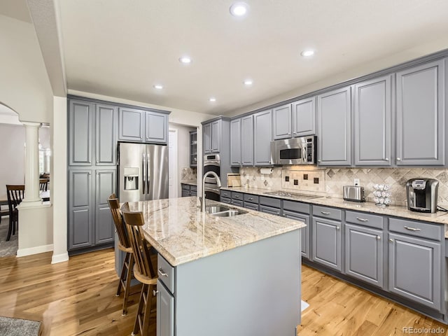 14310 Kalamath St, Westminster, CO 80023 - kitchen featuring gray cabinets, stainless steel appliances, decorative columns, and recessed lighting