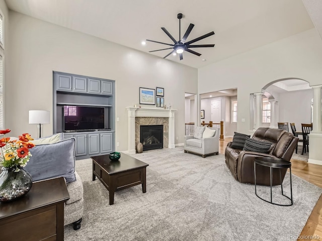 14310 Kalamath St, Westminster, CO 80023 - living area featuring ornate columns, ceiling fan, arched walkways, recessed lighting, and a premium fireplace