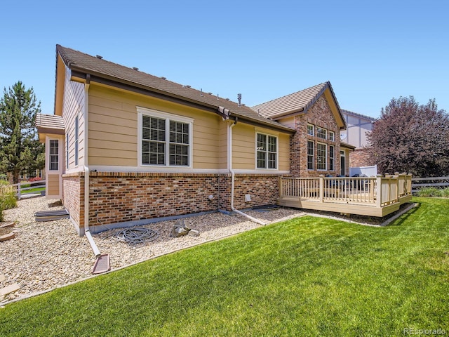 14310 Kalamath St, Westminster, CO 80023 - rear view of house with brick siding and a wooden deck