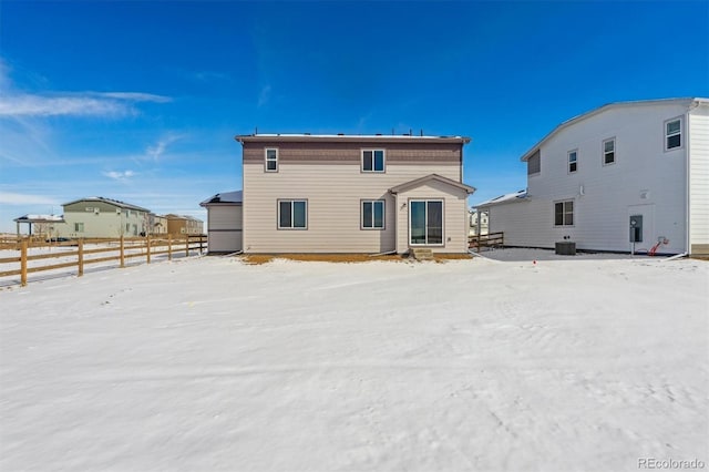 snow covered property with cooling unit