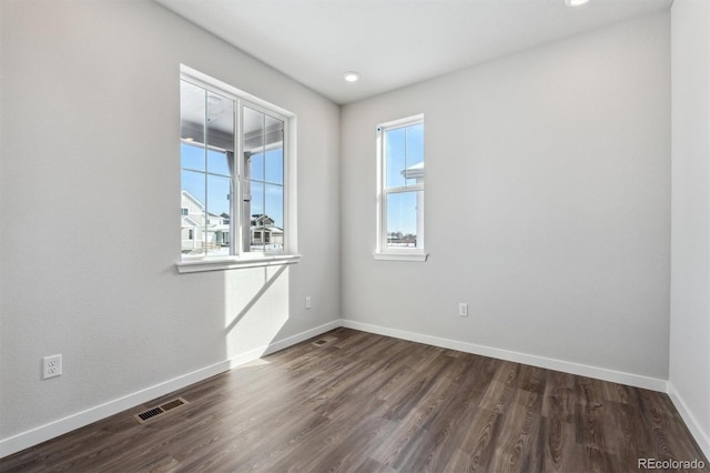 spare room with dark hardwood / wood-style flooring