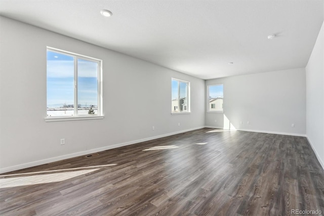 spare room featuring dark hardwood / wood-style flooring