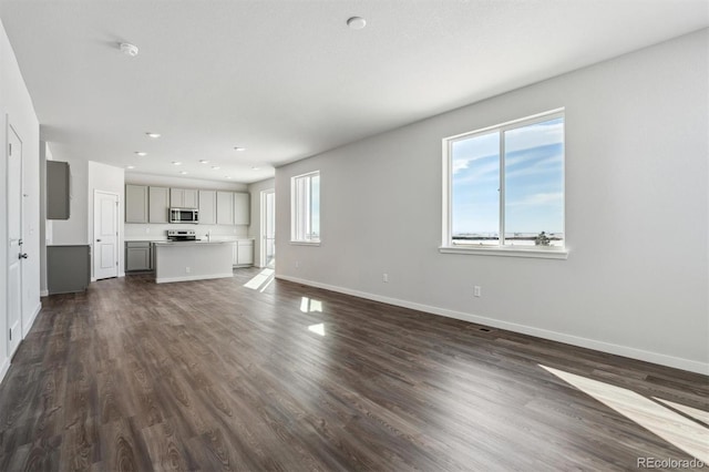 unfurnished living room featuring dark hardwood / wood-style flooring