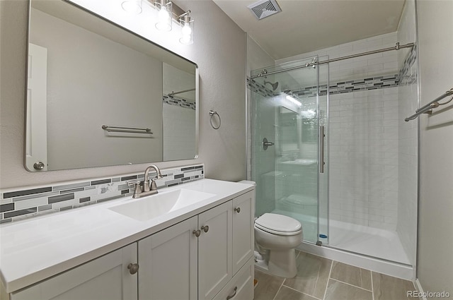 bathroom with an enclosed shower, vanity, toilet, and decorative backsplash