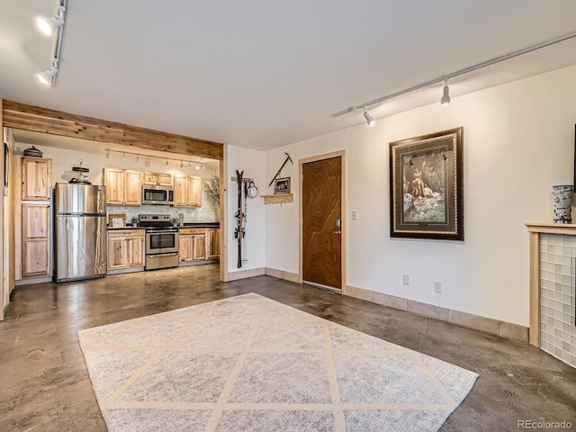 kitchen featuring decorative backsplash, light brown cabinets, and appliances with stainless steel finishes