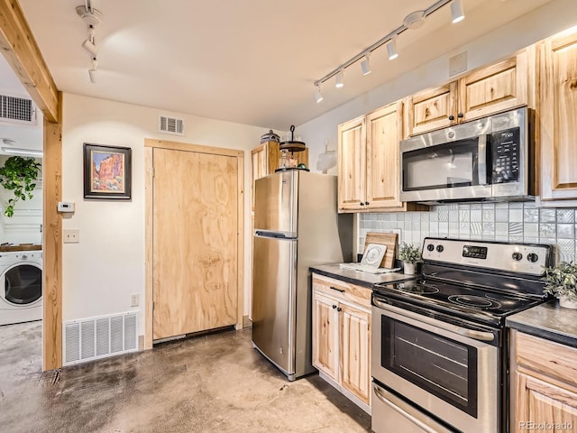 kitchen featuring light brown cabinetry, washer / dryer, concrete floors, stainless steel appliances, and decorative backsplash