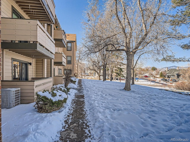 yard layered in snow with central AC