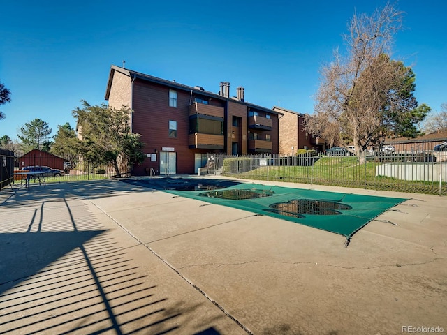 view of pool with a trampoline and a lawn