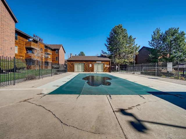 view of swimming pool with an outdoor structure and a patio area