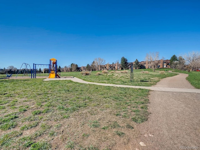 view of property's community with a playground and a lawn