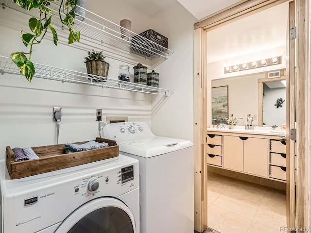 400 Zang St Unit 1-105, Lakewood, CO 80228 - washroom with washing machine and clothes dryer and light tile patterned flooring