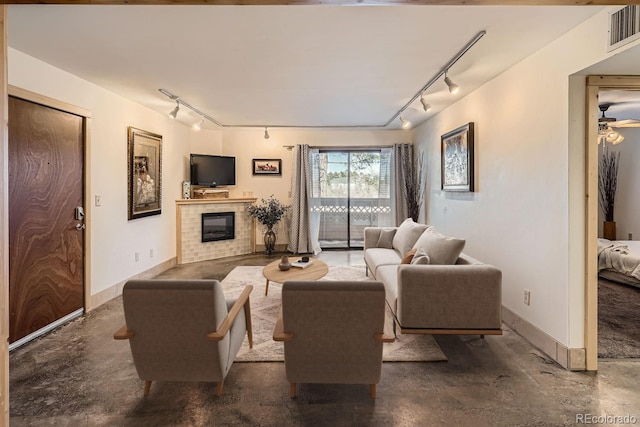 400 Zang St Unit 1-105, Lakewood, CO 80228 - living room with rail lighting, a tile fireplace, and concrete flooring